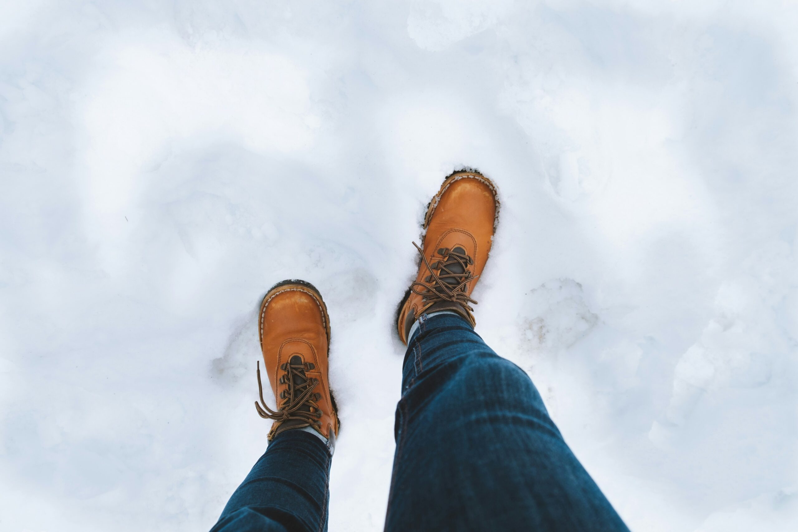Winter boots walking across snow and ice