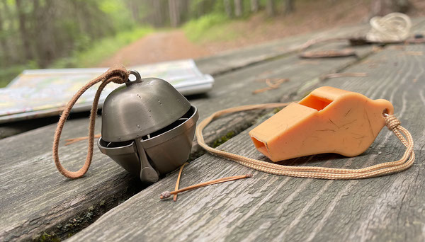 Bear Bell vs Hiking Whistle: What's Actually Useful? Bear Bell vs Hiking Whistle: What's Actually Useful? editorial illustration