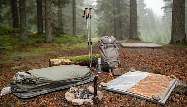 bivy vs emergency blanket in outdoor setting