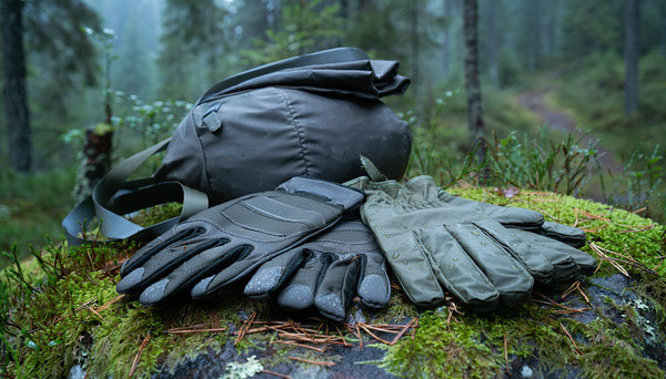 Waterproof Rain Mitts vs Hiking Gloves: Which Do You Need? Hiking gloves and waterproof rain mitts at a trailhead