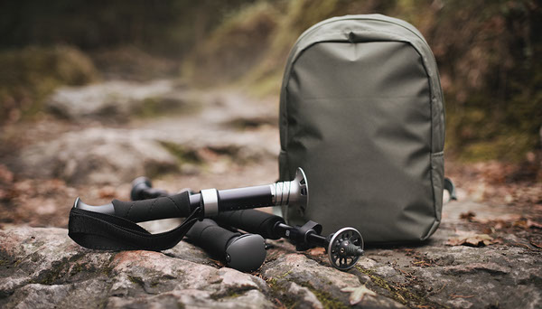 Are Collapsible Trekking Poles Worth It for Day Hikes? Collapsed trekking poles and hiking backpack on a rocky trail